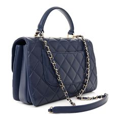 This is an authentic CHANEL Lambskin Quilted Medium Trendy CC Flap Dual Handle Bag in Blue. This stylish handbag is crafted of diamond quilted lambskin leather in blue. This refined bag features a reinforced leather top handle with dark silver links, a dark silver chain leather threaded shoulder strap with a shoulder pad, and a dark silver Chanel plate. The flap opens with a CC turn lock to a partitioned burgundy leather interior with a zipper and patch pockets. Leather Thread, Diamond Quilt, Leather Chain, Handle Bag, Leather Interior, Lambskin Leather, Blue Bags, Leather Top, Shoulder Pads