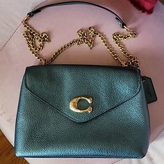 Stunning Metallic Green Coach Bag With Gold Hardware. Can Be Worn In Two Styles Shoulder Or Crossbody. Little Jewels On The Emblem In The Front Make This Piece Unique. Only Worn Once, Protective Stickers Still Intact On Hardware. Fits A Lot! Green Coach Bag, Green Leather Bag, Bags Coach, Coach Bag, Green Leather, Coach Bags, Green And Gold, Gold Hardware, Leather Bag