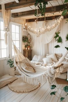 a bedroom with a hammock hanging from the ceiling and pillows on the floor