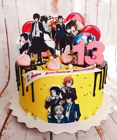 a birthday cake decorated with anime characters on it's top and the number 13