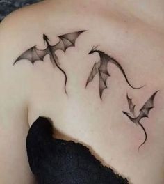 a woman's shoulder with three bats on it