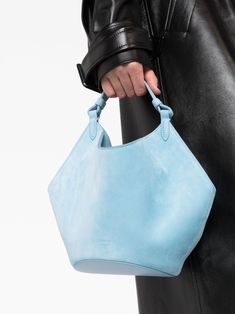 mini Lotus suede tote bag from KHAITE featuring baby blue, calf suede, slouch body, single top handle, tonal stitching, leather lining and main compartment. Size Info UNI Color Detail Clear Blue Made In Italy Material Calf Leather 100% Season One Fall-Winter Season Two Fall-Winter Product bags.. Brand Khaite Size And Fit Width 12,6 in / 32 cm Height 4,72 in / 12 cm Depth 5,51 in / 14 cm Handle 6,69 in / 17 cm Blue Leather Bag With Round Handle, Blue Leather Bags With Round Handle, Blue Top Handle Bucket Bag For Evening, Blue Leather Shoulder Bag With Rolled Handles, Luxury Tote Bags, Suede Tote Bag, Slouch Bags, Suede Tote, Novelty Bags