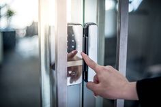 a person is pressing the button on a door handle to open it with their finger