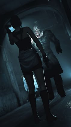 two people dressed in dark clothing standing next to each other and one person holding a knife