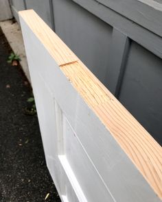 the side of a house that has been boarded up and is being used as a planter