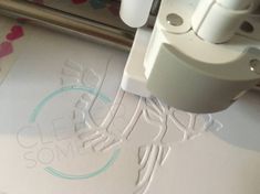 a close up of a machine cutting out paper