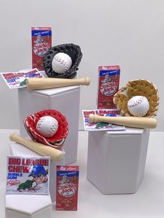 baseballs, mitts, and other sports memorabilia are displayed in boxes on a table