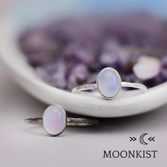 This lovely Periwinkle Blue Chalcedony Ring in Sterling Silver features an 8 mm x 6 mm oval natural Blue Chalcedony cabochon that has been securely set in a highly polished fine silver bezel. The band is made of a sturdy round Sterling Silver wire that has a hammered texture around the entire band. Sterling Silver Wire, Sterling Silver Plate, 8 x 6 mm Oval Gemstone Dimensions - Widest point - 8 mm, Band - 1.5 mm Includes free resizing and 1 year warranty Celestial Oval Cabochon Rings, Silver Celestial Jewelry With Oval Cabochon, Adjustable Oval Cabochon Moonstone Ring, Celestial Opal Birthstone Ring In Oval Shape, Celestial Oval Opal Birthstone Ring, Dainty Oval Cabochon Ring, Sterling Silver Oval Opal Cabochon Ring, Sterling Silver Oval Cabochon Opal Ring, Sterling Silver Moonstone Ring Oval Cabochon