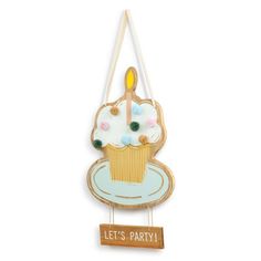 a wooden sign with a cupcake on it that says let's party hanging from the wall