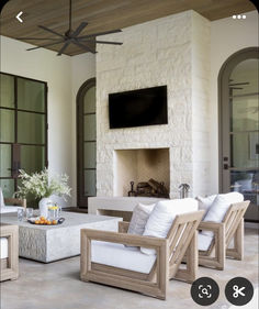 a living room filled with furniture and a flat screen tv mounted to the wall over a fireplace