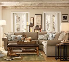 a living room filled with lots of furniture and decor on top of a hard wood floor