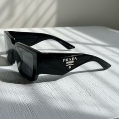 Like New Prada Sunglasses In All Black And Classic Logo On The Side. Comes With Everything. Prada Symbole Sunglasses, Prada Accessories, Prada Sunglasses, Classic Logo, Colored Sunglasses, On The Side, All Black, Sunglasses Accessories, Prada