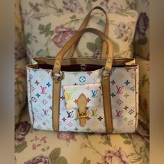 Pre Loved Limited Edition Louis Vuitton Takashi Murakami Aurelia Mm Tote Bag With Shopping Bag, Dust Bag And Luggage Tag. Everything Seen In Picture She Does Have Wear But Still In Beautiful Useable Condition. Please See All Pictures. This Was Shown Thoroughly On My Live Made In France Highlights White/Multicolour Signature Monogram Multicolour Canvas Leather Trim Two Long Top Handles Lobster Claw Fastening Main Compartment Internal Zip-Fastening Pocket With Replaced Zipper Pull Approximate Size Daily Use Multicolor Monogram Canvas Bag, Multicolor Rectangular Monogram Canvas Bag, Luxury Multicolor Everyday Bags, White Monogram Canvas Shoulder Bag, White Monogram Canvas Shopping Bag, Everyday White Monogram Canvas Bag, White Monogram Canvas Satchel Shoulder Bag, White Monogram Canvas Shoulder Bag With Double Handle, White Monogram Canvas Shoulder Bag For Everyday Use