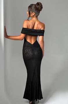 Wow them in Stephanie, a sheer maxi made in our premium stretch floral lace that's super elegant and sexy. With a fit and flare silhouette, this dress is finished with off the shoulder, bardot neckline, low cut out back, contour seams to the body and ruched detail to the bum. Layer over a basic bralet and high waisted mini shorts.     Colour: Black.  Premium stretch sheer floral lace.  Lined in mesh.  Fit and flare silhouette.  Bardot neckline.  Low cut out back.  Contour seams to the body.  Ruc Black Prom Dress Backless, Low Cut Back Dress, Homecoming Dresses Corset, Black Lace Formal Dress, Low Cut Dress, Debs Dress, Midi Dress Wedding Guest, Classy Wardrobe, Insta Poses