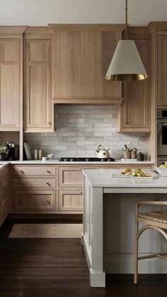 a large kitchen with wooden cabinets and white counter tops, along with an island in the middle