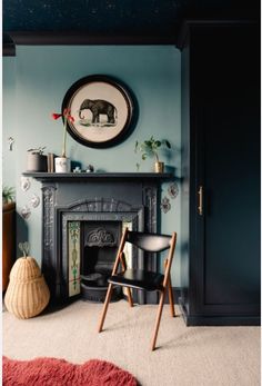 a living room filled with furniture and a fire place in front of a painting on the wall