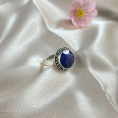 Aurora is a beautiful ring featuring a smooth round cushion cut Lapis Lazuli nestled in a finely detailed, sterling silver frame. Aurora is the perfect pick-me-up when you need that extra sparkle with it's ethereal, vintage-inspired design in silver. Authentic Sivalya Lapis Lazuli Lapis Lazuli: Inner Power - Wisdom - Manifestation Hallmarked Metal: 925 Sterling Silver Gemstone Size: 10mm x 10mm Cut: Round Shaped Smooth Cabochon Timeless Cabochon Sapphire Ring Gift, Timeless Round Cabochon Sapphire Ring, Timeless Gift Sapphire Cabochon Ring, Classic Round Crystal Birthstone Ring, Classic Sapphire Cabochon Rings, Timeless Silver Round Birthstone Ring, Sapphire Signet Promise Ring, Adjustable Gemstone Signet Ring, Classic Adjustable Sapphire Promise Ring