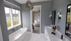 a large bathroom with two sinks and a bathtub in the middle of the room