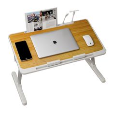 an apple computer sitting on top of a wooden desk next to a mouse and cell phone