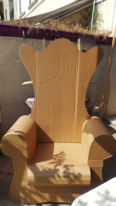 a cardboard chair that is sitting on the ground