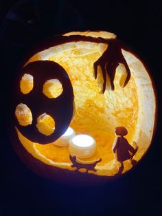 a pumpkin carved to look like it has hands coming out from the hole in it