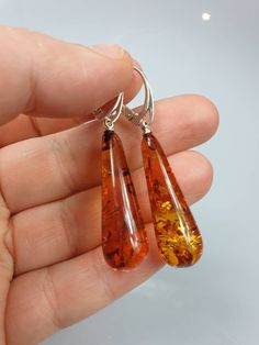 Brown Amber earrings. Not pressed but natural. Each earrings are teardrop shape. Each earrings can be slightly different due amber is being natural and each is handmade. Some are shorter some longer. You can see a few pictures if you want to see exact earrings I have at a moment please contact me. Item has natural imperfections. Length about 5 cm with lever back. Due to amber being natural, each of my jewelry is unique and even the same models can be slightly different. Please contact me for mor Brown Long Drop Earrings For Gift, Handmade Amber Teardrop Earrings, Amber Teardrop Earrings Gift, Amber Teardrop Earrings As A Gift, Amber Teardrop Drop Earrings For Gift, Hypoallergenic Amber Teardrop Earrings, Hypoallergenic Amber Teardrop Jewelry, Teardrop Earrings With Natural Inclusions, Multicolor Earrings