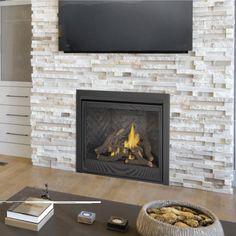 a living room with a fire place and flat screen tv on the wall above it