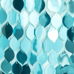 blue and black glass tiles are arranged on the wall