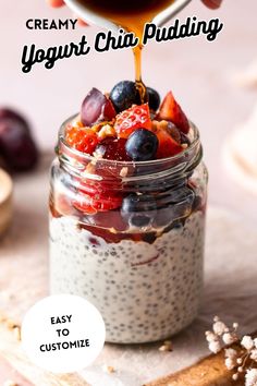 a jar filled with yogurt chia pudding next to berries and almonds