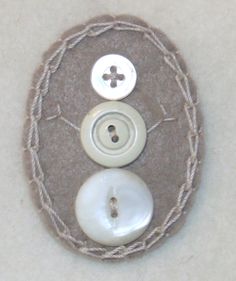 two white buttons sitting on top of a piece of cloth