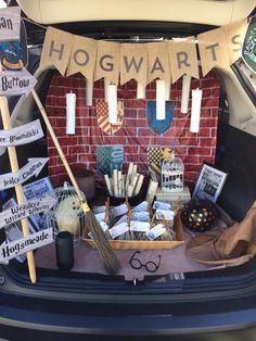 the trunk of a car is filled with harry potter memorabilia and props, including brooms