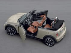 an image of a mini convertible car with its doors open