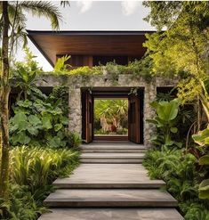 an entrance to a house surrounded by greenery