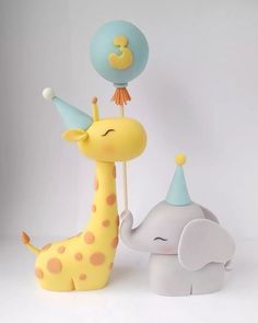 an elephant and giraffe are standing next to each other with hats on their heads