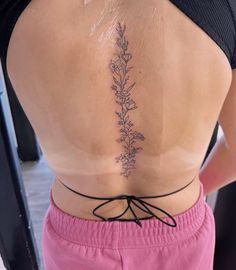 the back of a woman's body with flowers on it