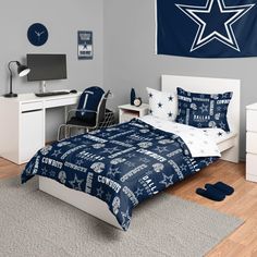 a bed room with a neatly made bed and a blue star wall hanging above it