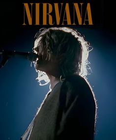 nirvana appearing on the cover of their album, in front of a microphone and stage