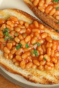 two pieces of bread with baked beans on them