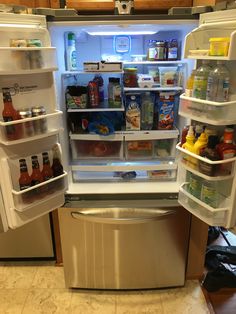 an open refrigerator with food and drinks in it