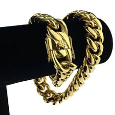 Men's 20" long x 18mm wide Cuban choker. 24k gold plated over solid stainless steel. Chunky cuban chain weighs well over 290 grams - has a premium feel. Stylish, strong and secure box lock clasp. Take your game to the next level with this solid stainless steel chain necklace. 100% FREE SHIPPING in USA. Order now! Cuban Link Bracelet In Stainless Steel With Gold Chain, Gold Stainless Steel Cuban Link Bracelet With Curb Chain, Gold Chain Cuban Link Bracelet In Stainless Steel, Stainless Steel Cuban Link Bracelet With Gold Chain, Gold Cuban Link Chunky Chain Bracelet, Gold Cuban Link Bracelet With Chunky Chain, Gold Stainless Steel Jewelry With Curb Chain, Gold Stainless Steel Curb Chain Jewelry, Gold Stainless Steel Cuban Link Bracelet