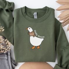 "This Chilly Goose Sweatshirt with a fun twist from Silly Goose Sweatshirts fits like a well-loved favorite. A Perfect way to share your love of Gooses and Yes Im Cold in your own unique way with this high quality super soft and comfy cotton sweater!! Get your one of a kind Aesthetic Trendy Sweatshirt! This Silly Goose Sweater will definitely make a statement & is the perfect Gift!! Seeing their big smile is worth to gift this retro sweatshirt . Happiness is one click away! Made with a thick ble Novelty Cotton Crew Neck Sweatshirt, Novelty Long Sleeve Cotton Tops, Novelty Cotton Long Sleeve Tops, Fall Novelty Cotton Tops, Novelty Cotton Tops For Fall, Cotton Novelty Long Sleeve Tops, Goose Sweater, Kind Aesthetic, Goose Sweatshirt