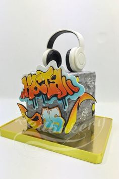 a pair of headphones sitting on top of a box with graffiti written on it