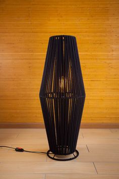 a black lamp sitting on top of a wooden floor