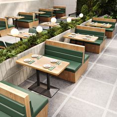 an outdoor seating area with wooden tables and green benches