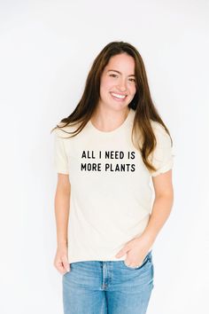 "All I need is more...plants. Product Info - Sizing: We highly recommend viewing our size chart photo before ordering. - Cream, Olive, and Slate Grey: 100% organic cotton // Mustard & Mauve: 100% Cotton Care Instructions Wash in cold water with a natural detergent. Air dry or turn inside out and dry on low. Shipping Info - Orders ship out from our fulfillment center in South Dakota within 2-3 business days via USPS First Class. Upgraded mailing services are available. - We ship worldwide. US Spring Relaxed Fit T-shirt With Plant Details, Casual Relaxed Fit T-shirt With Plants, Crew Neck Cotton T-shirt With Plant Details, Cotton Crew Neck T-shirt With Plant Details, Cotton Crew Neck T-shirt With Plants, Cotton T-shirt With Plant Detail, Short Sleeve, White Letter Print T-shirt For Gardening, Everyday Crew Neck Top With Plant Print, Homeschool Shirts