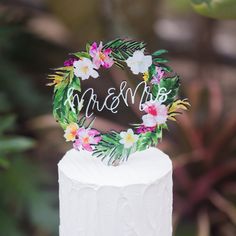 a white cake topped with a floral wreath