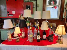 a table topped with lamps and bottles of alcohol