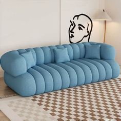 a blue couch sitting on top of a white rug