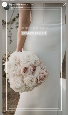 a woman in a white dress holding a bouquet of flowers and wearing a wedding gown