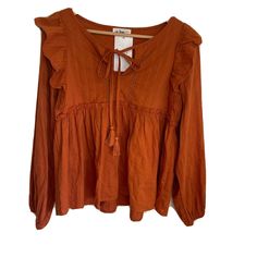 In Loom Long Sleeve Tunic Ruffle Blouse Casual Tassel Boho Rust Color Women Sz Small New With Tags - Nwt Pit To Pit- 18” Length- 22” Sleeves-25” Spring V-neck Top With Back Tassel Tie-up, Fall V-neck Peasant Top With Ruffles, Casual Vacation Blouse With Tassel Ties, Casual Blouse With Tassel Ties For Vacation, Bohemian Ruffled Peasant Top For Vacation, Casual Peasant Top With Tassels For Fall, Casual V-neck Peasant Top With Tassels, Vacation Peasant Top With Tassel Ties, Fall Bohemian Peasant Top With Ruffles